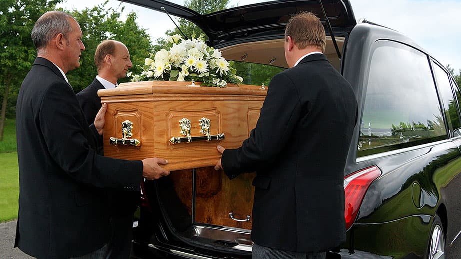 A funeral director consulting compassionately with a bereaved family