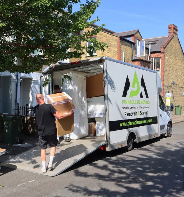 Dubai removals crew loading a customer's belongings into a branded moving truck